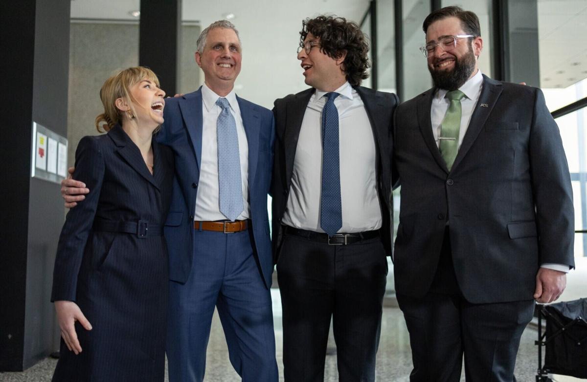 “Broadview Six” defendants Kat Abughazaleh, from left, Michael Rabbitt, Andre Martin and Brian Straw embrace outside the Dirksen U.S. Courthouse after federal prosecutors dismissed all remaining counts, May 21, 2026.